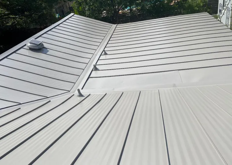 Solar attic fan installed on a metal roof for Roof Ventilation in Kinston